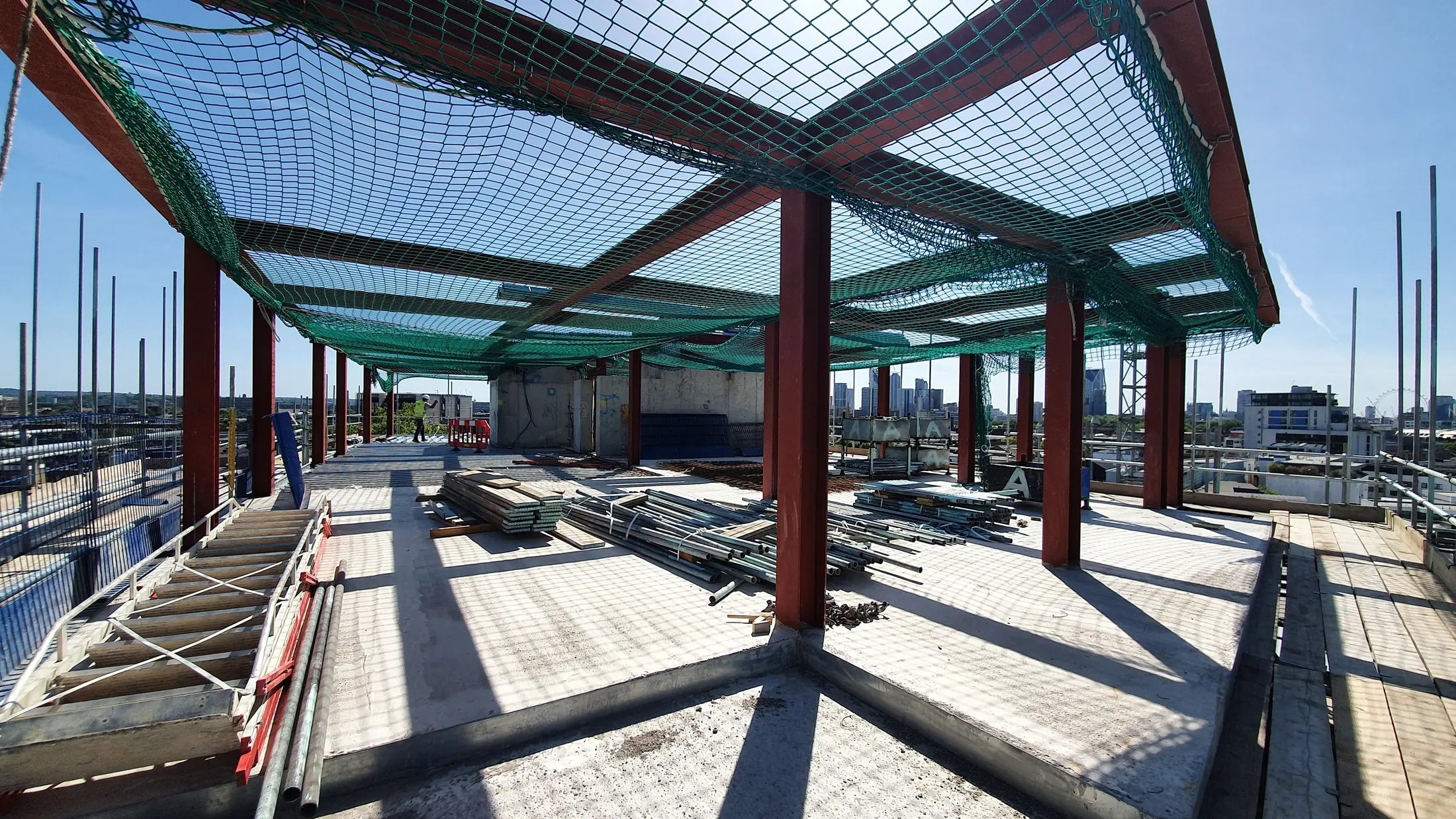 Steel roof frame and safety netting during construction at Tower Bridge Road